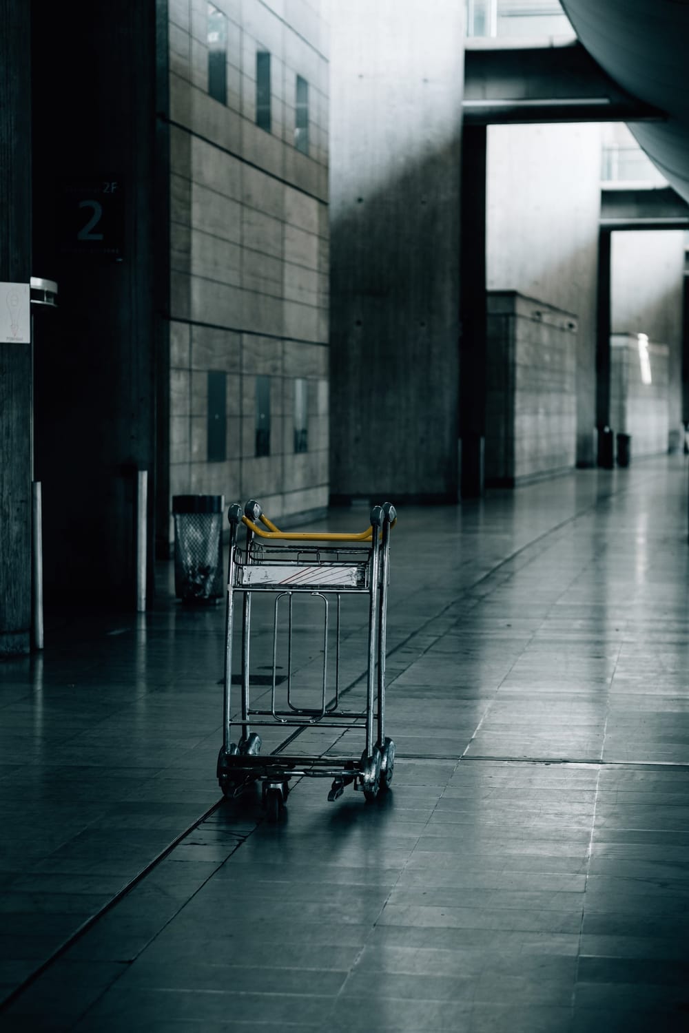 empty-luggage-cart-in-an-industrial-hallway
